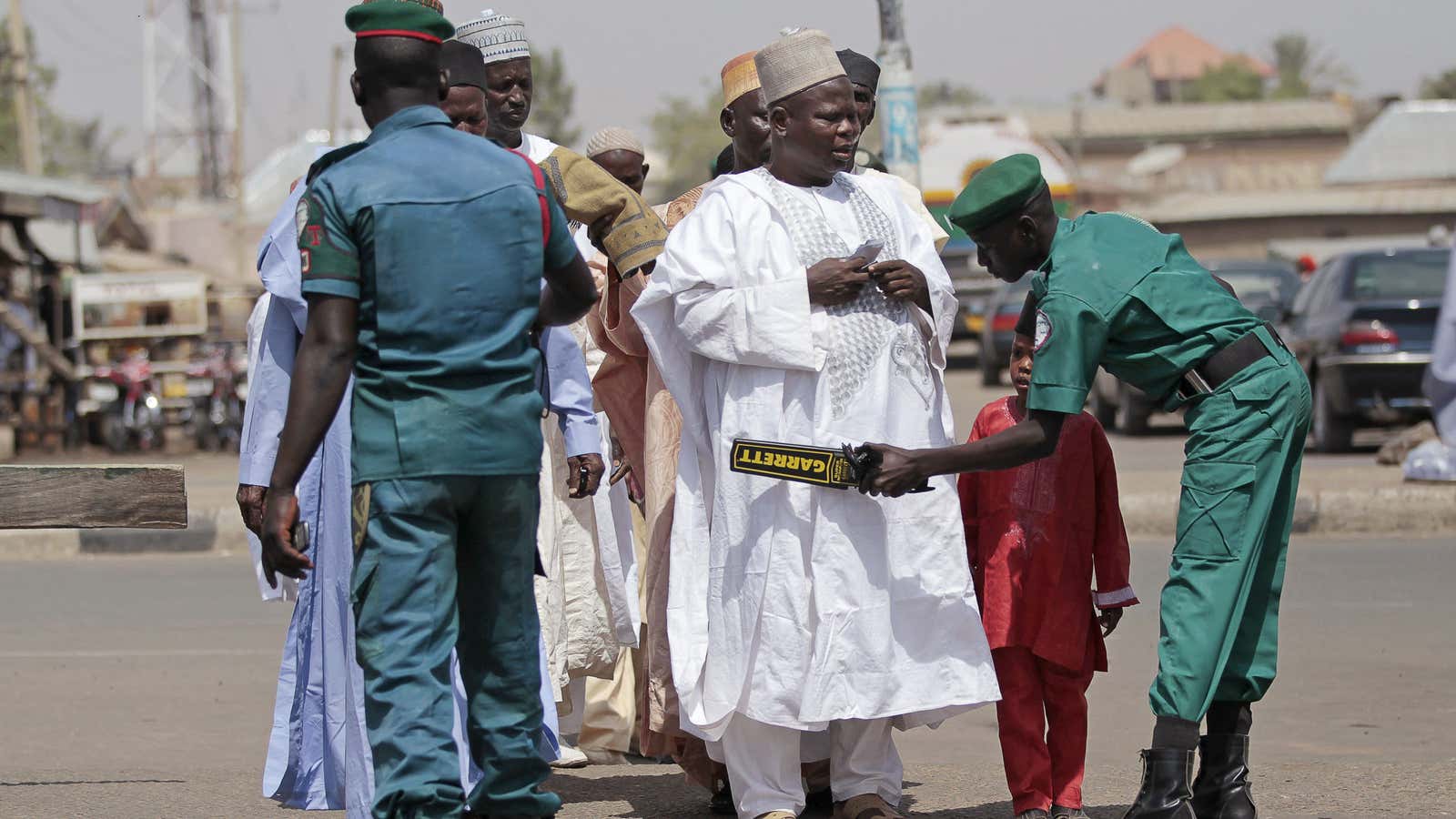 Members of volunteer group Hisbah screen Muslim worshippers heading for Friday prayers in Miyetti, Gombe in Nigeria.