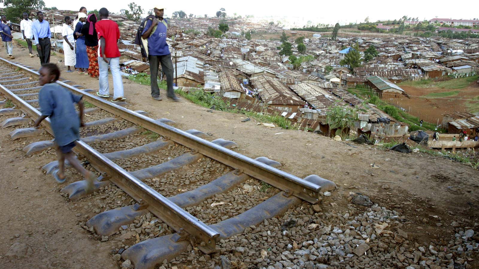 People walk along the uprooted Kenya-Uganda railway line in Nairobi.