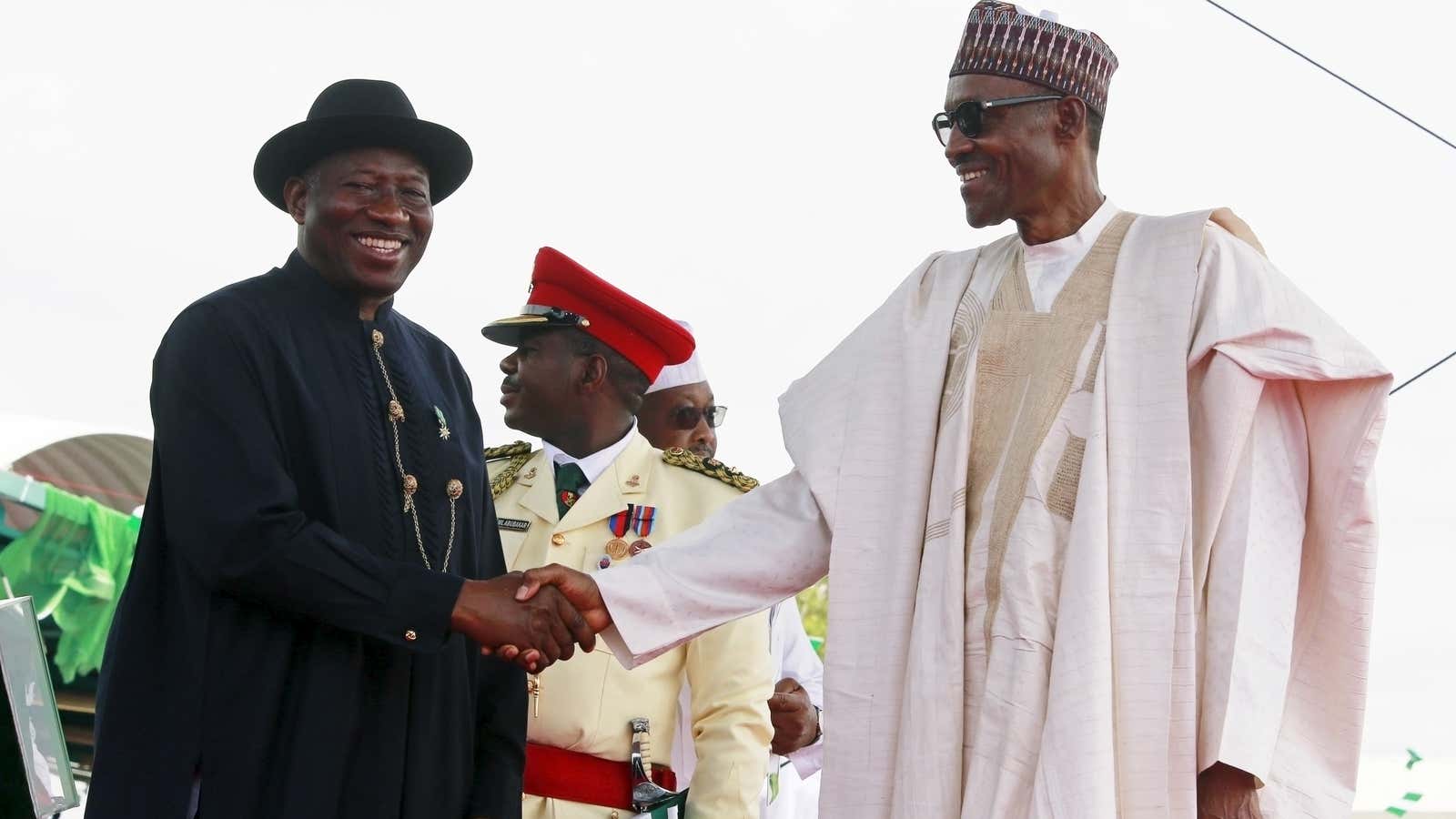 Nigeria’s outgoing president Goodluck Jonathan (L) congratulates incoming President Muhammadu Buhari on May 29.