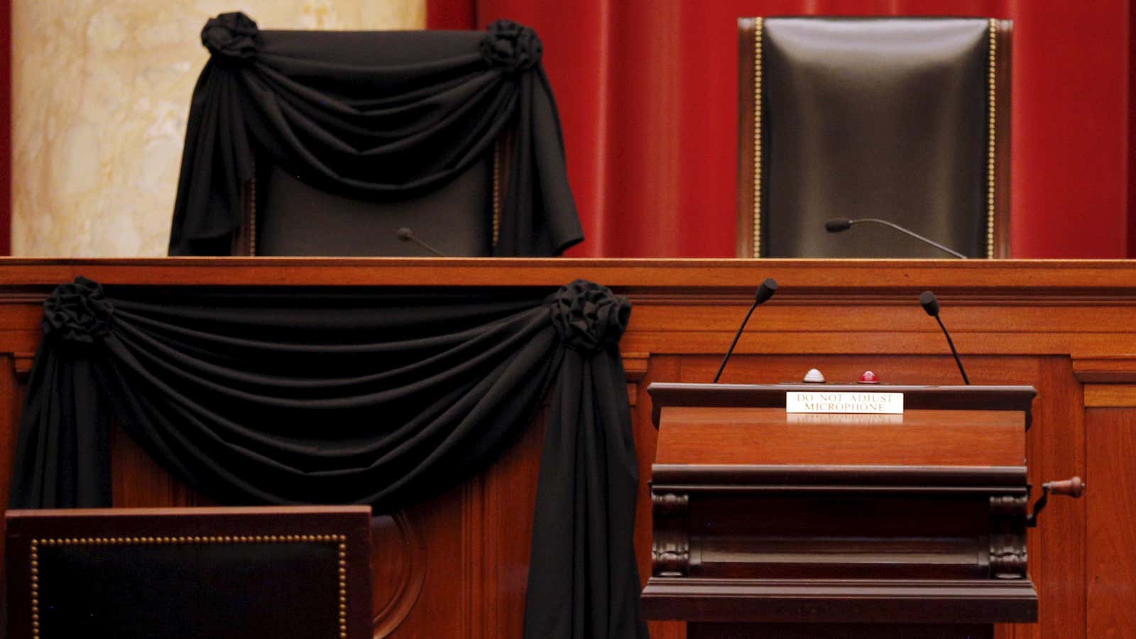 The bench of late Supreme Court Justice Antonin Scalia is seen draped with black wool crepe in memoriam .