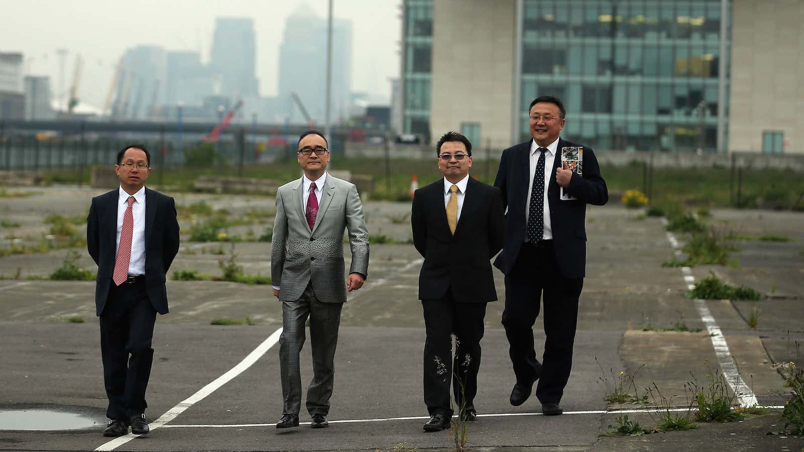 Xu Weiping (second from left) surveys his latest development project, the Royal Albert Dock in east London.