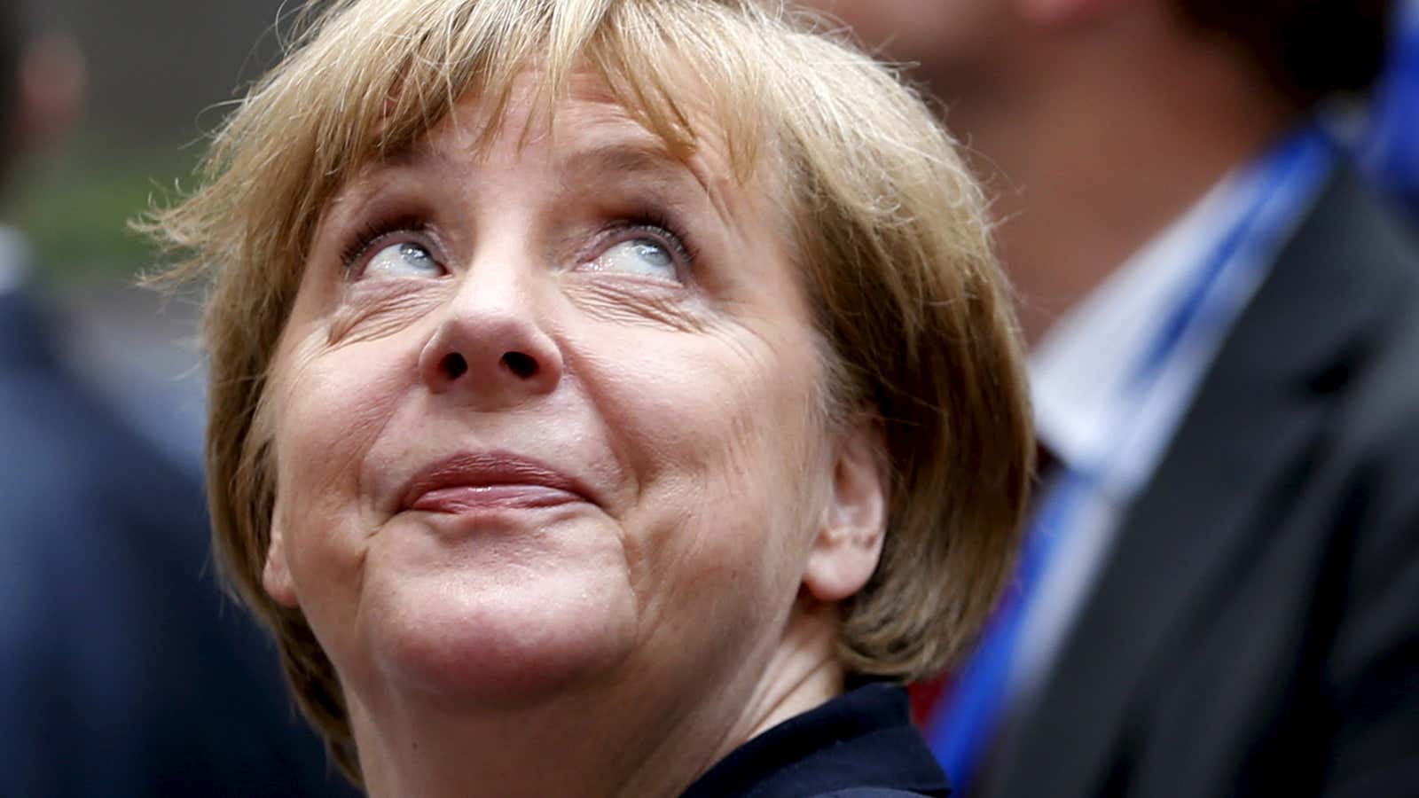 Germany’s Chancellor Angela Merkel looks up as she arrives at an emergency euro zone summit in Brussels, Belgium.