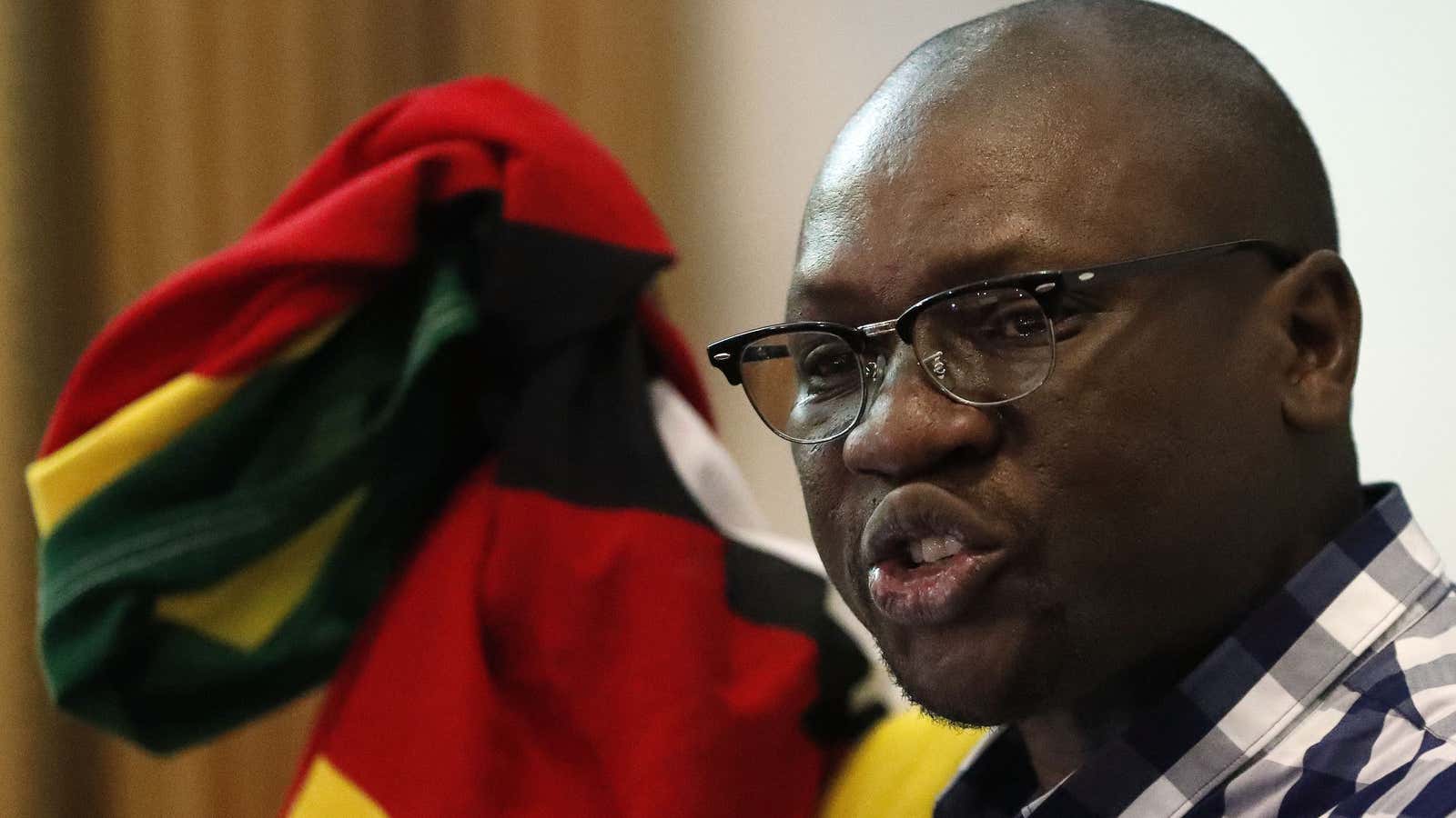 Zimbabwean pastor Evan Mawarire, holds his national flag whilst addressing supporters at the University of the Witwatersrand in Johannesburg, South Africa on July 28.