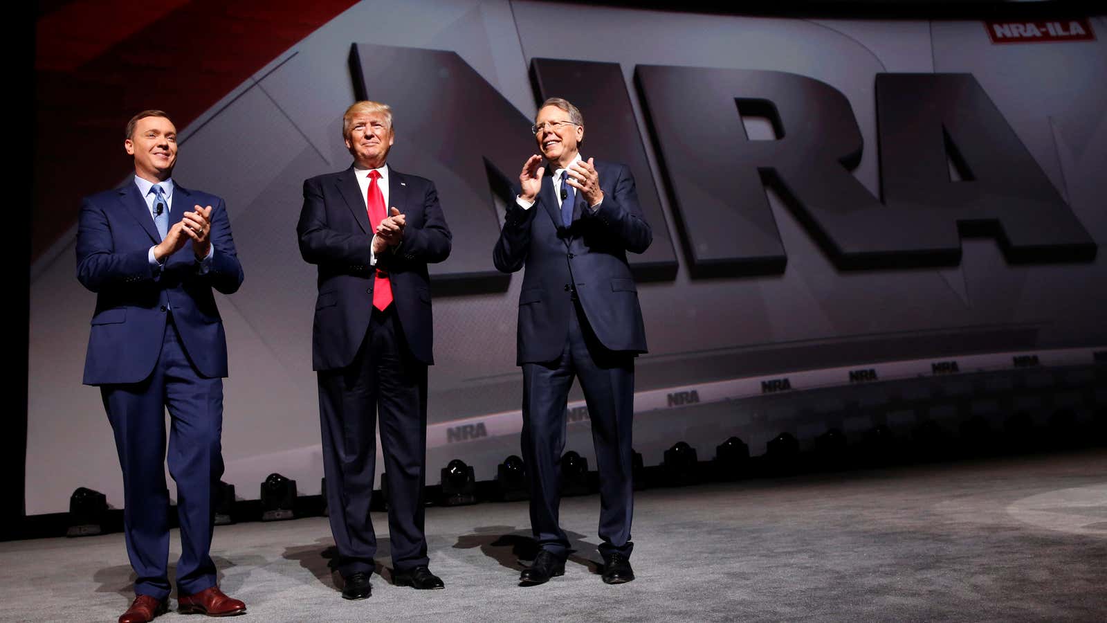 Trump speaks at a NRA leadership forum in 2017, flanked by the group’s executive director Chris Cox (L) and CEO Wayne LaPierre (R).