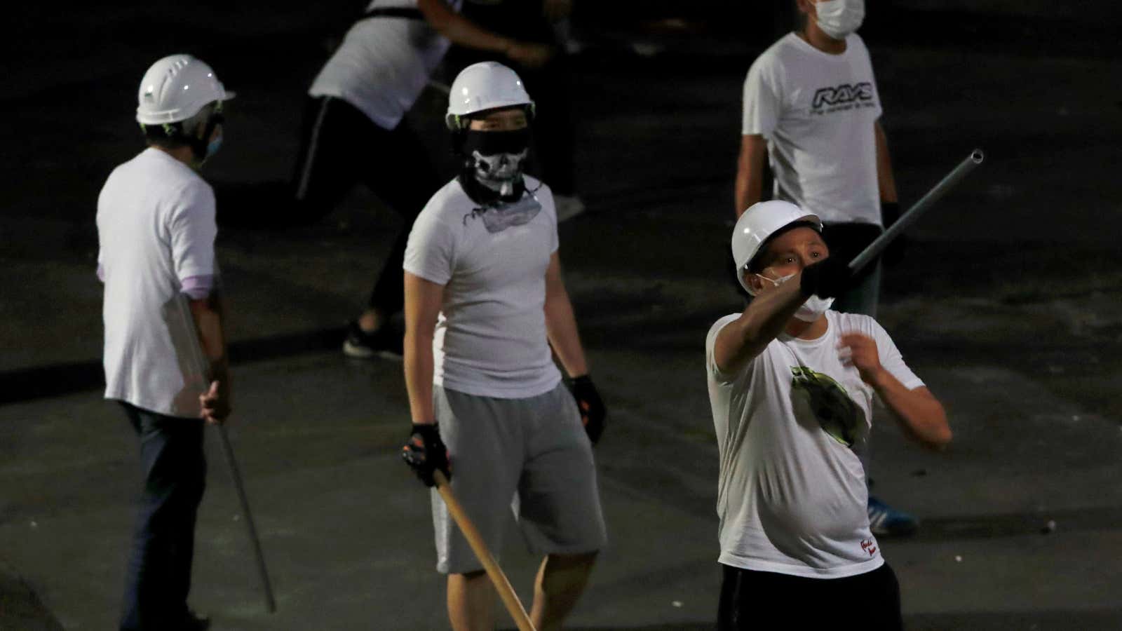 Men in white T-shirts with poles are seen in Yuen Long after attacked anti-extradition bill demonstrators at a train station, in Hong Kong, China July…