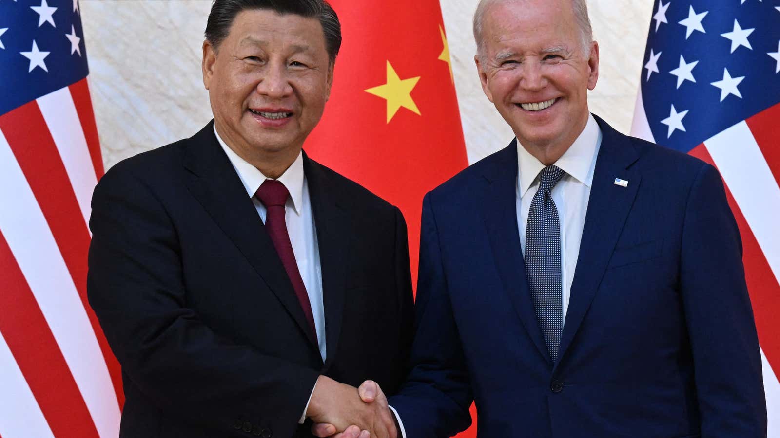 US President Joe Biden (R) and China&#39;s President Xi Jinping (L) shake hands as they meet on the sidelines of the G20 Summit in Nusa Dua on the Indonesian resort island of Bali on November 14, 2022.