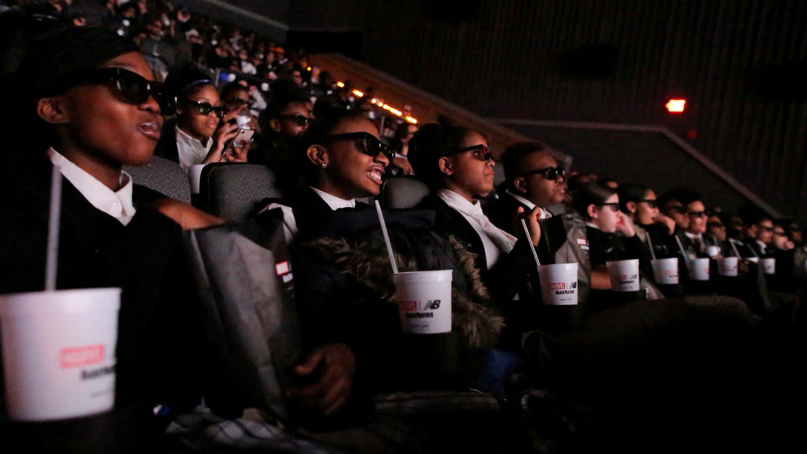 A group of students from the Capital Preparatory Harlem School watch a screening of the film “Black Panther” on its opening night.