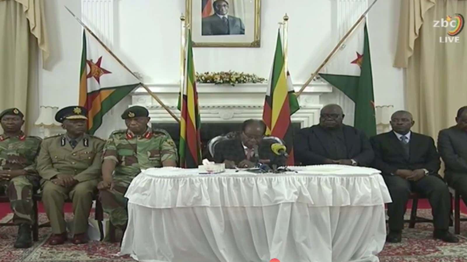Robert Mugabe gives a statement in Harare, surrounded by senior military officials.