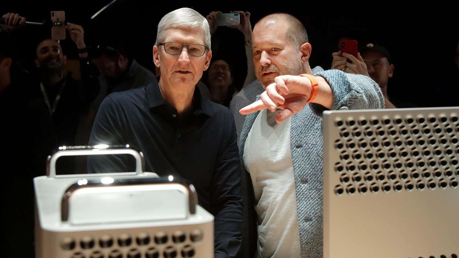FILE – In this Monday, June 3, 2019 file photo, Apple CEO Tim Cook, left, and chief design officer Jonathan Ive look at the Mac…
