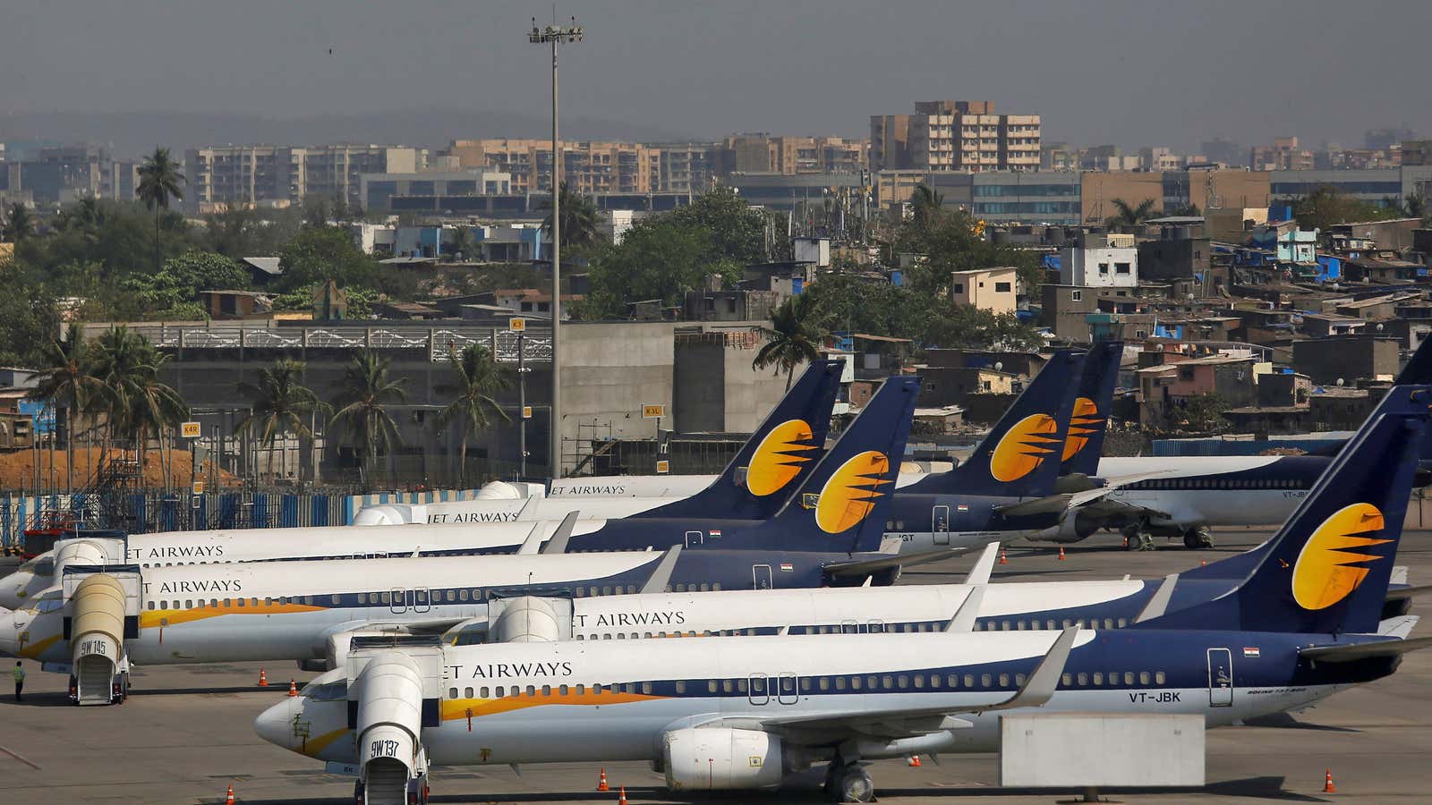 Jet Airways aircrafts are seen parked as an IndiGo Airlines aircraft prepares to land at the Chhatrapati Shivaji Maharaj International Airport in Mumbai, India, April 18, 2019. REUTERS/Francis Mascarenhas