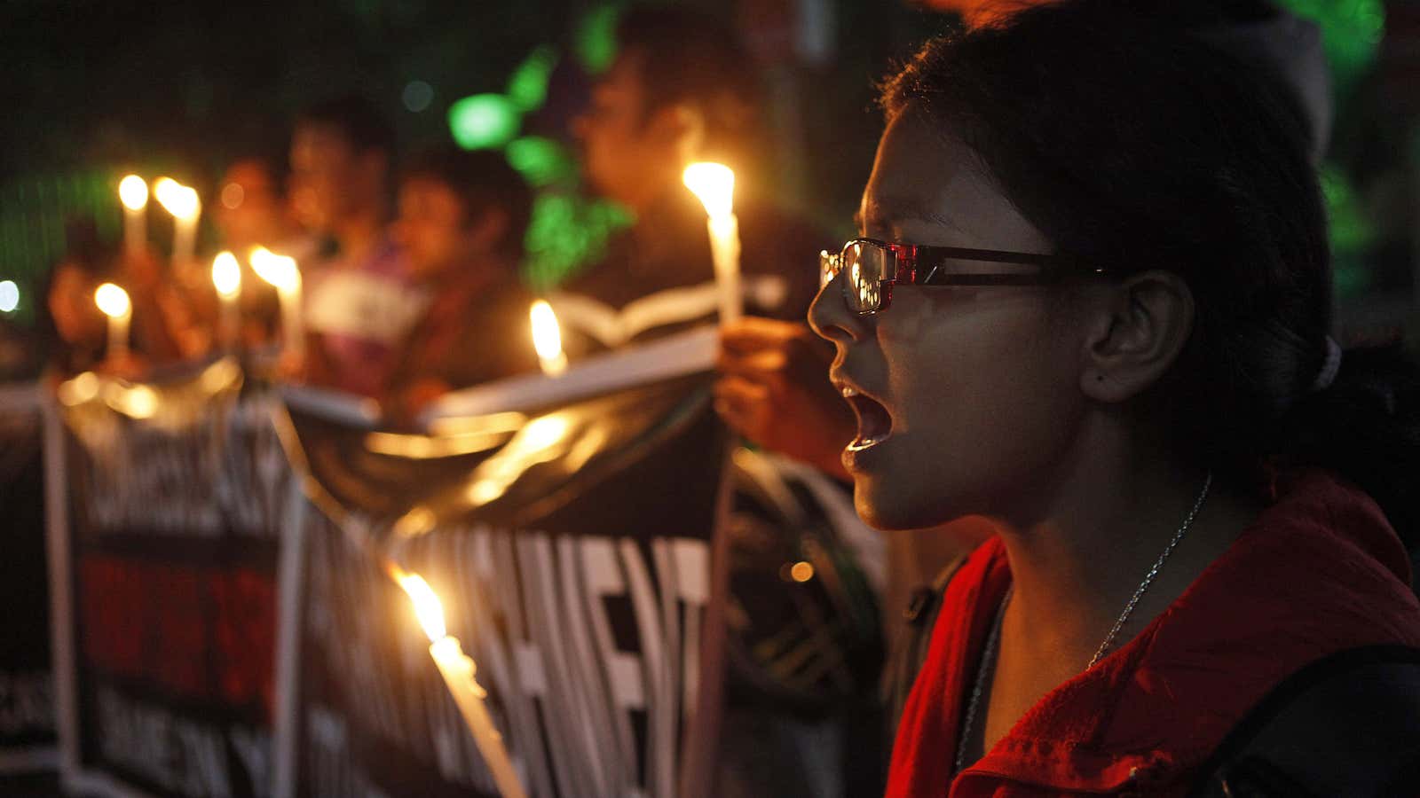 Never forget: A woman holds vigil in memory of a 23-year-old student who was gang raped last month on a moving bus in Delhi.