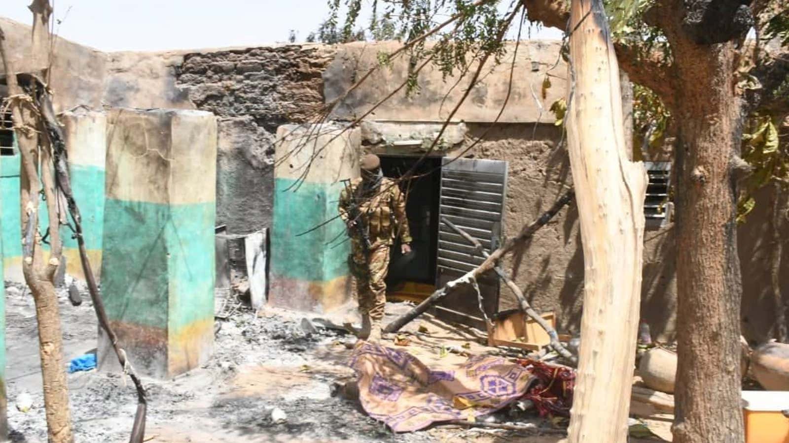 A soldier walks amid the damage after an attack by gunmen on Fulani herders in Ogossagou, Mali March 25, 2019.