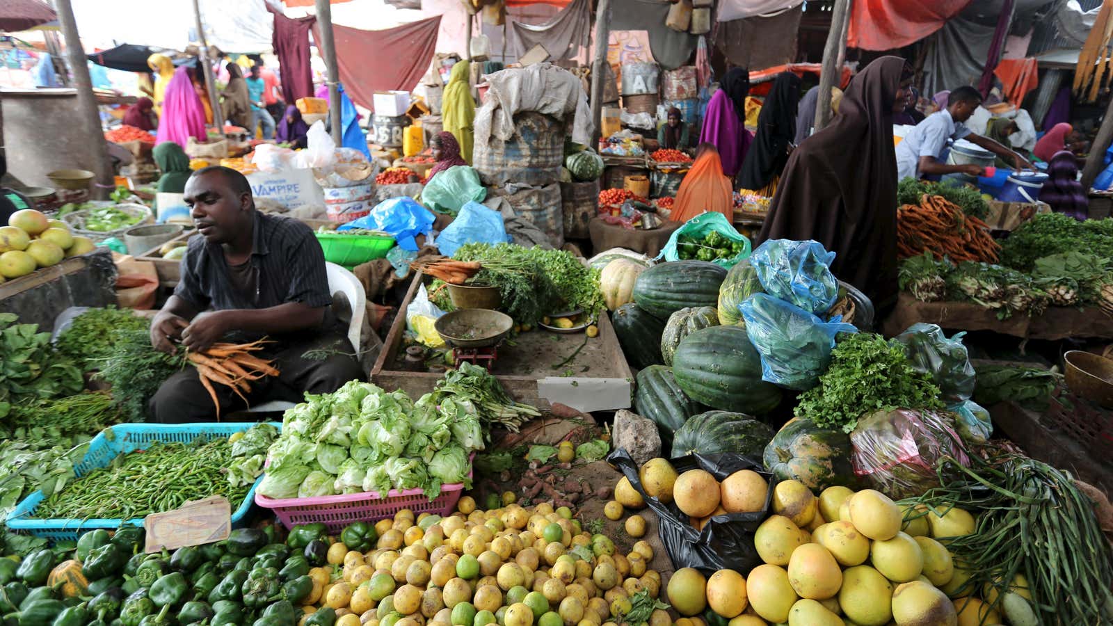 Somali traders at markets like this one in Mogadishu are increasingly more likely to do business using cellphones instead of cash.