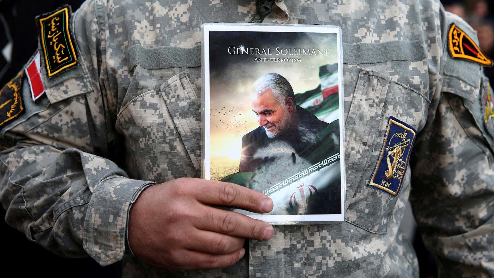 A demonstrator in Tehran holds a picture of Qassem Soleimani during a protest against the US assassination of the Iranian major general.