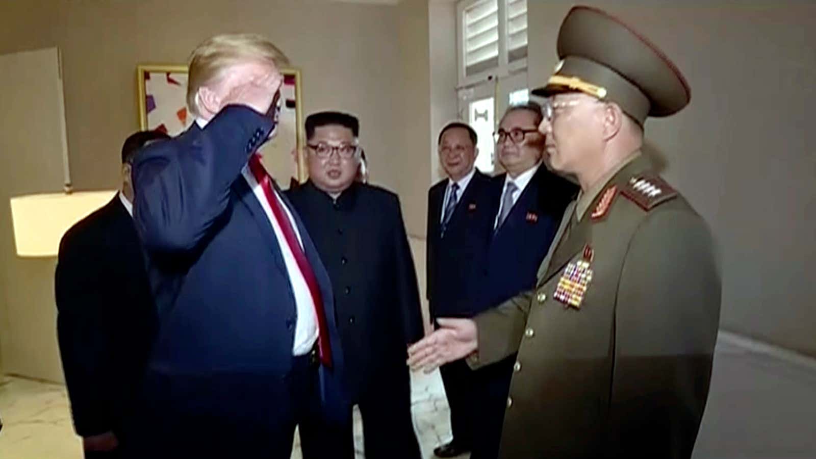 Donald Trump salutes a North Korean general during the Singapore summit.