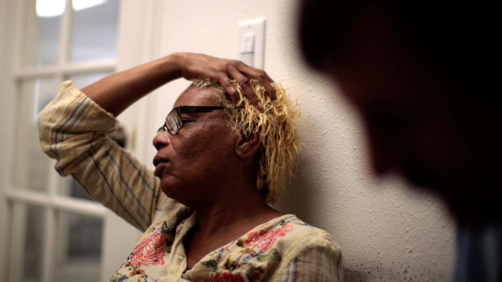 A woman waits outside a doctor’s office to receive treatment for her migraine.