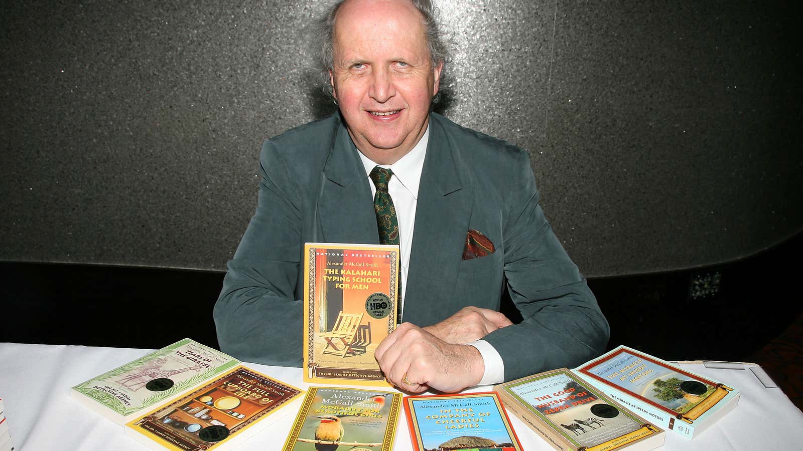 McCall Smith poses with some of the books from his bestselling series set in Botswana.