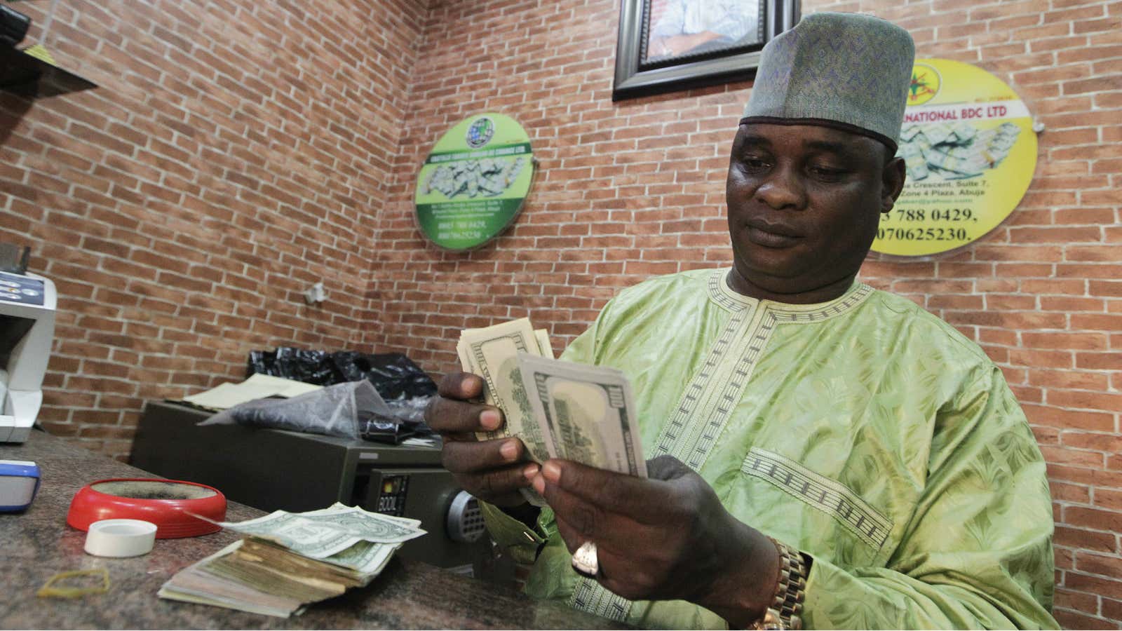 A bureau de change operator counts U.S. currency notes in Abuja.