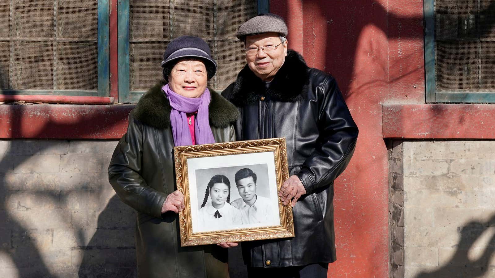 Huang Fusheng, 83, and his wife Tang Lanfang, 80, pose with their wedding photo taken in 1958.