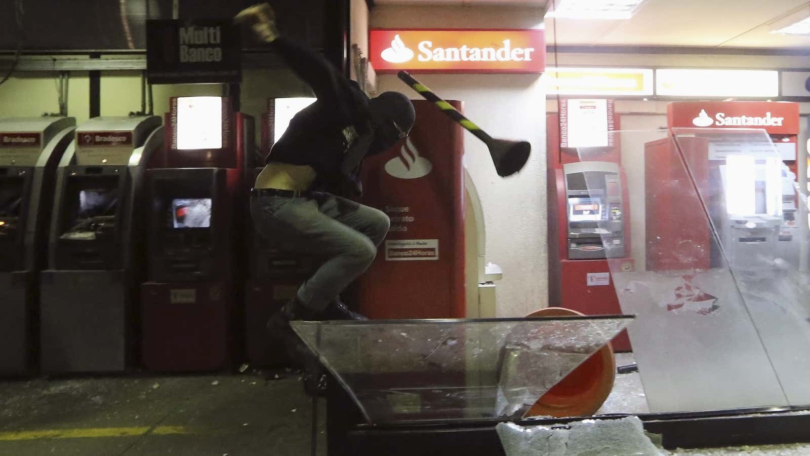 A man has it out with an ATM during protests in Sao Paulo in October.