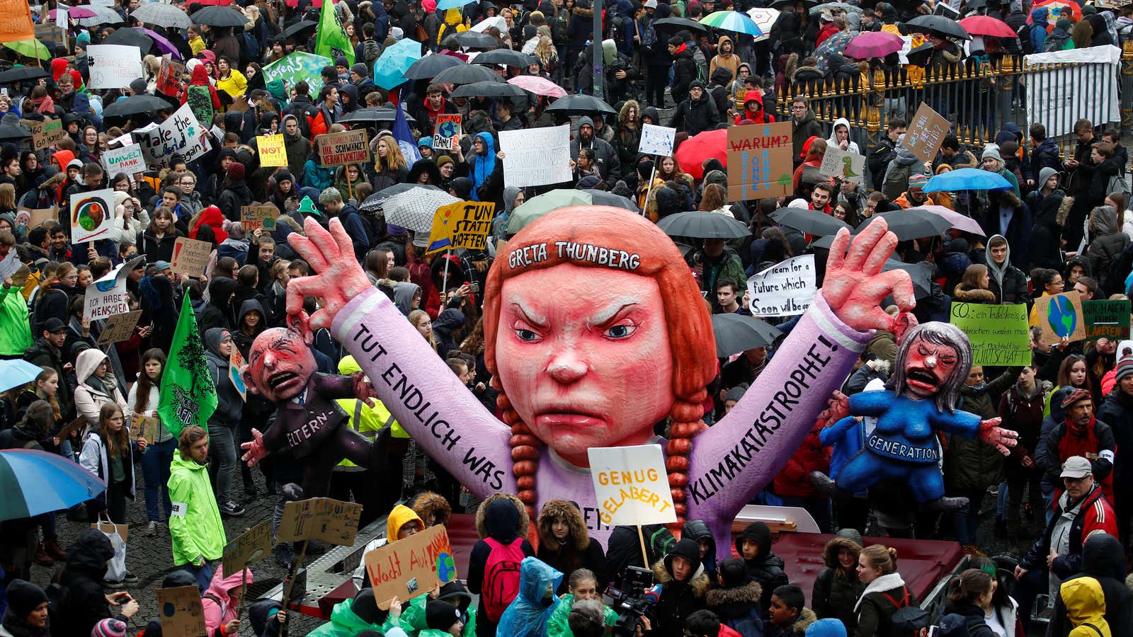 Students use a carnival float depicting Swedish environmental campaigner Greta Thunberg in Dusseldorf.