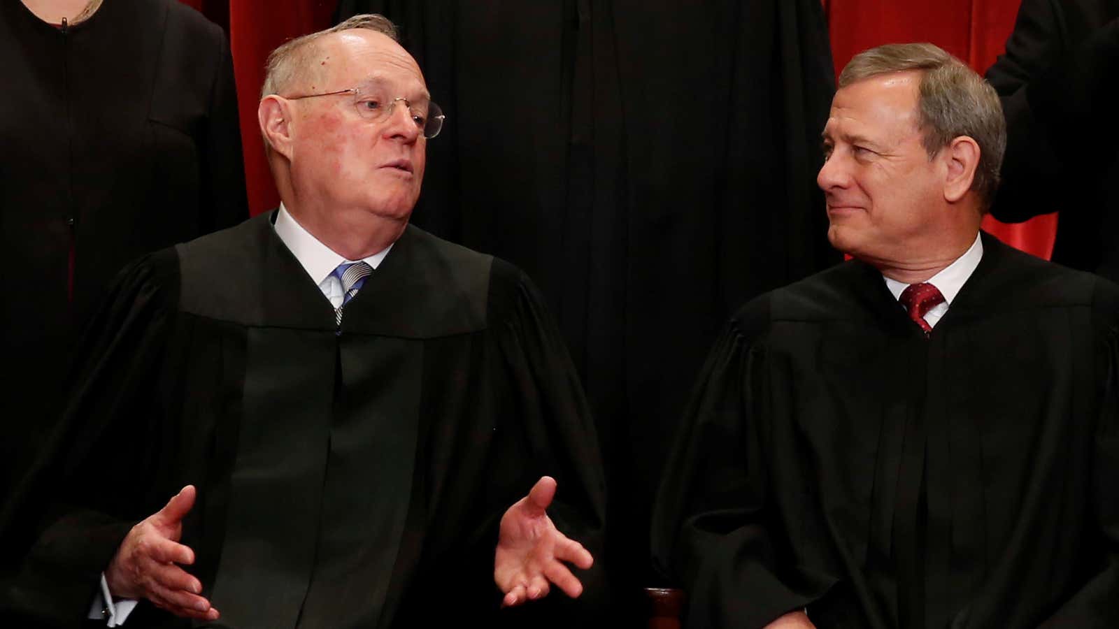 Chief justice John Roberts (right) talks with justice Anthony Kennedy (left) during a photo shoot at the United States Supreme Court.