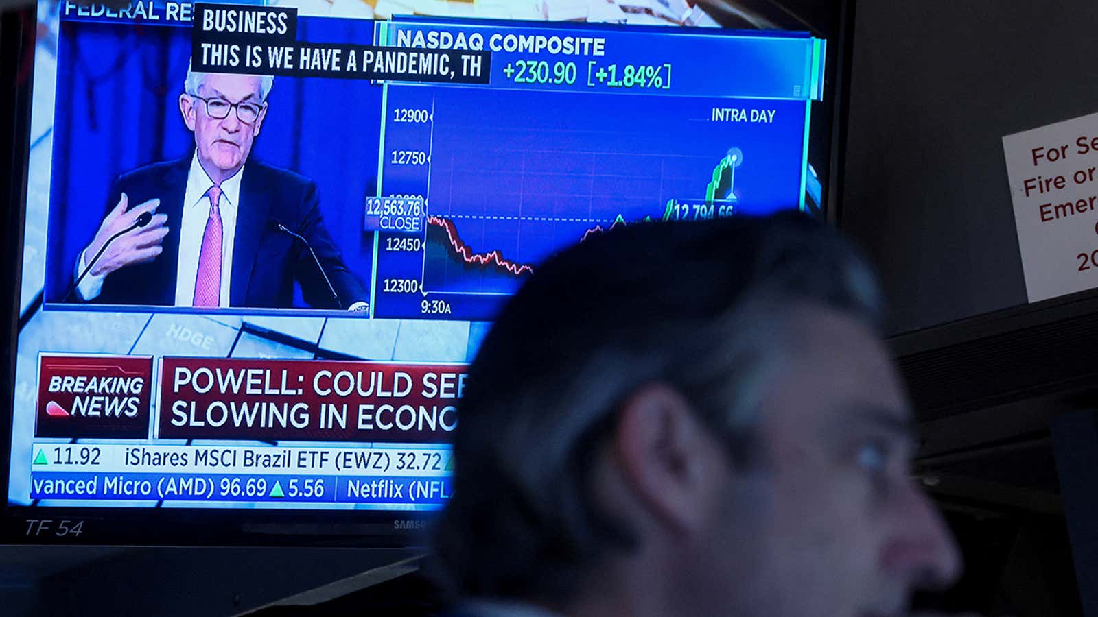A trader works, as Federal Reserve Chair Jerome Powell is seen delivering remarks on a screen, on the floor of the New York Stock Exchange (NYSE) in New York City, U.S. May 4, 2022. REUTERS/Brendan McDermid