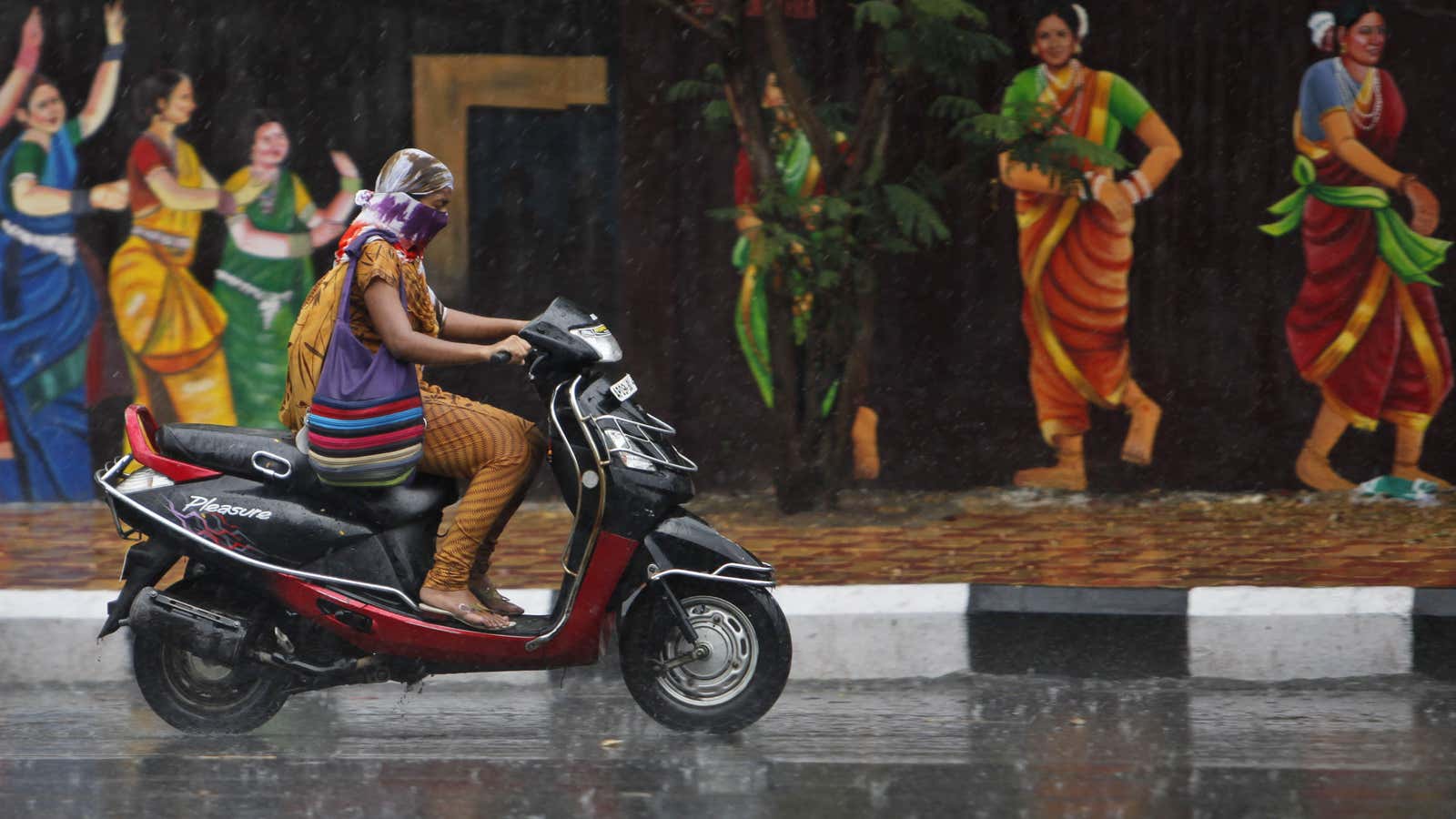 Zipping through the rain in Hyderabad.
