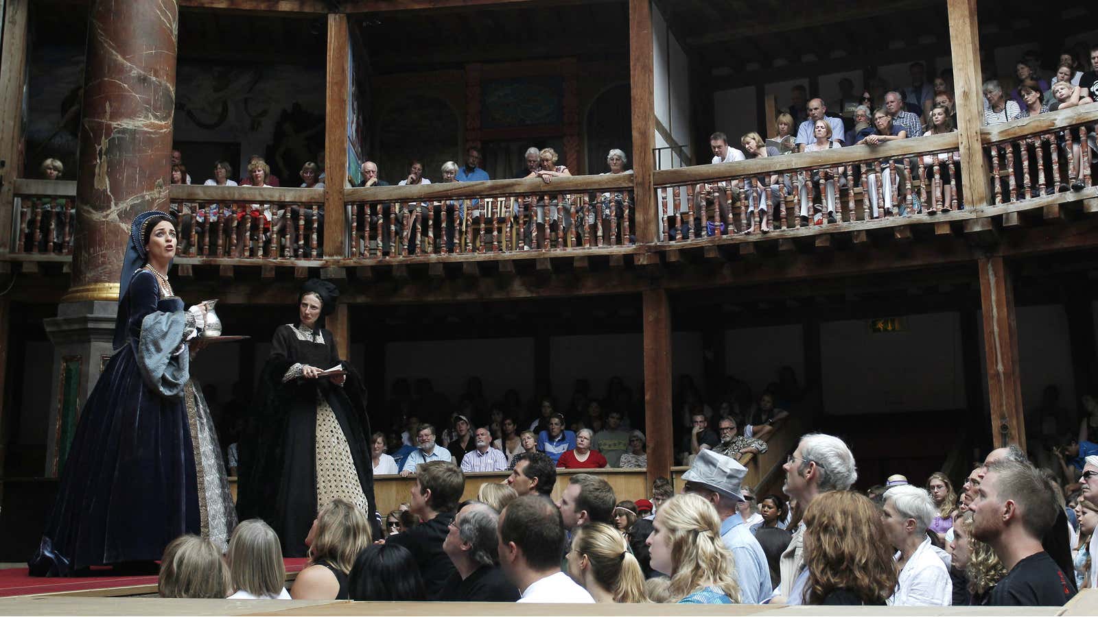 The audience watches Miranda Raison (L) perform as Anne Boleyn in Shakepeare’s Henry VIII at the Globe Theatre in London July 6, 2010. William Shakespeare’s…