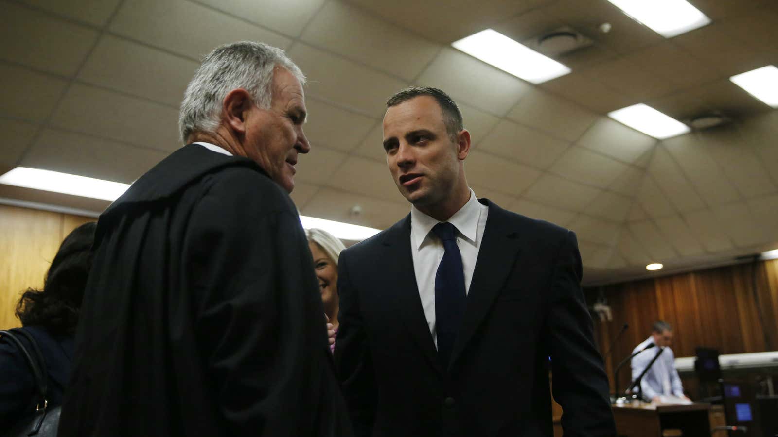 Oscar Pistorius, right, talks with his defense attorney Barry Roux, left, at his trial last year.