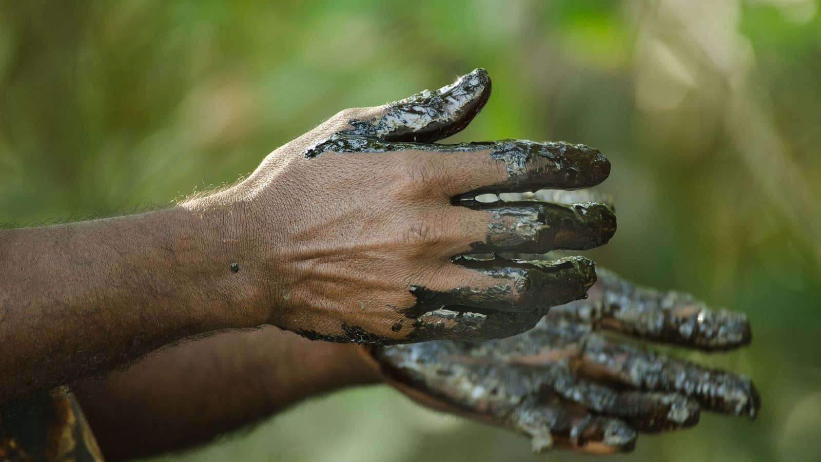 Locals are using their bare hands to collect the oil residue.