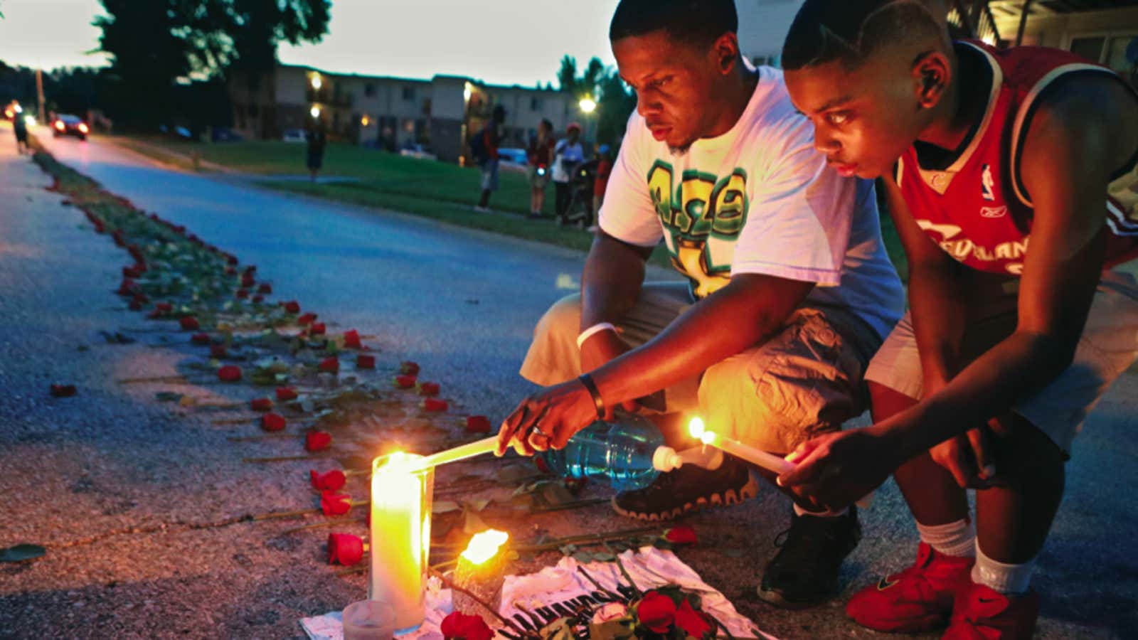 Theo Murphy, left, of Florissant, Missouri, and his brother Jordan Marshall light candles.