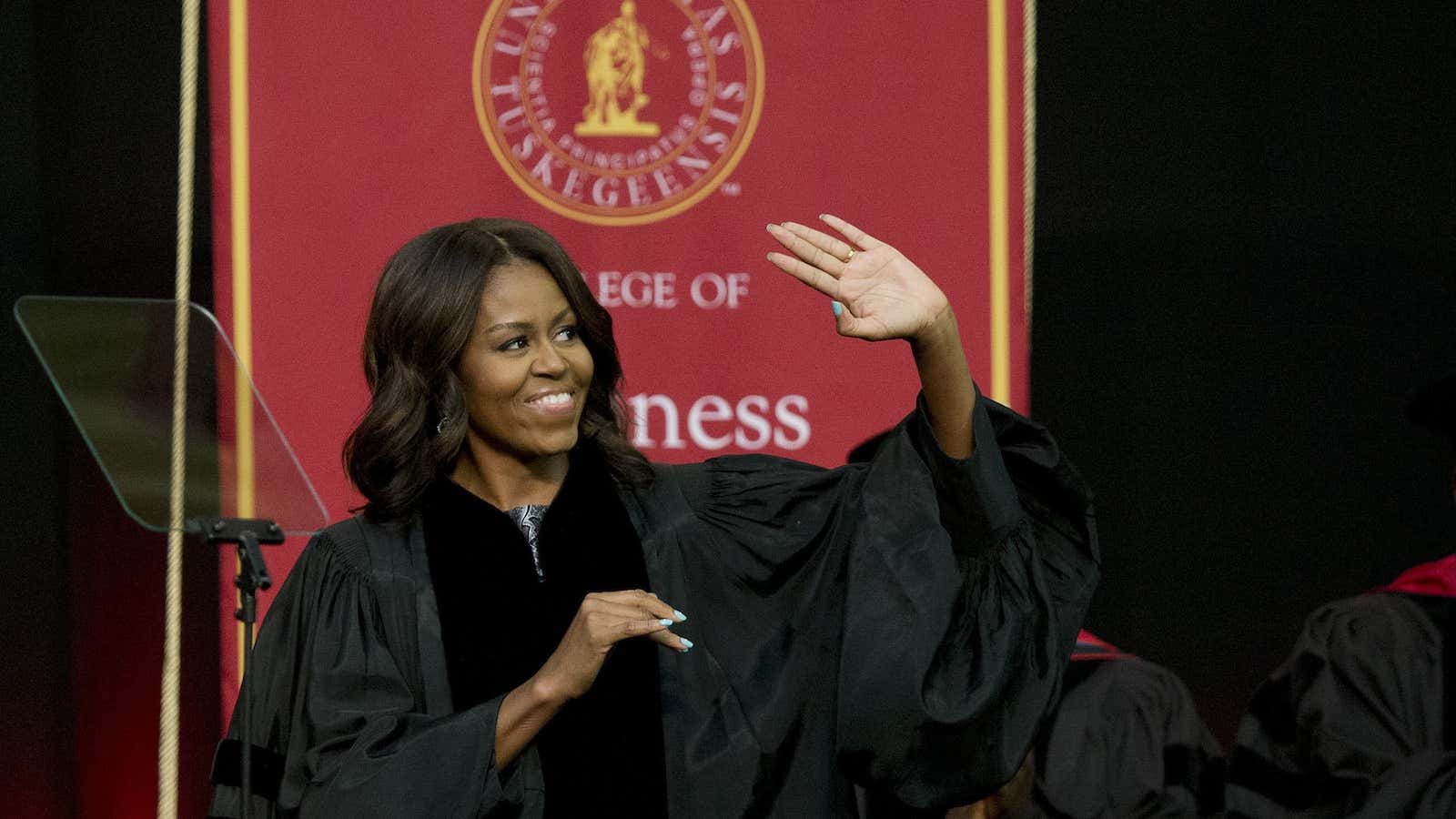 First lady Michelle Obama waves towards the crowd after walking out on stage just before she delivers the commencement address at Tuskegee University, Saturday, May 9, 2015, in Tuskegee, Alabama.