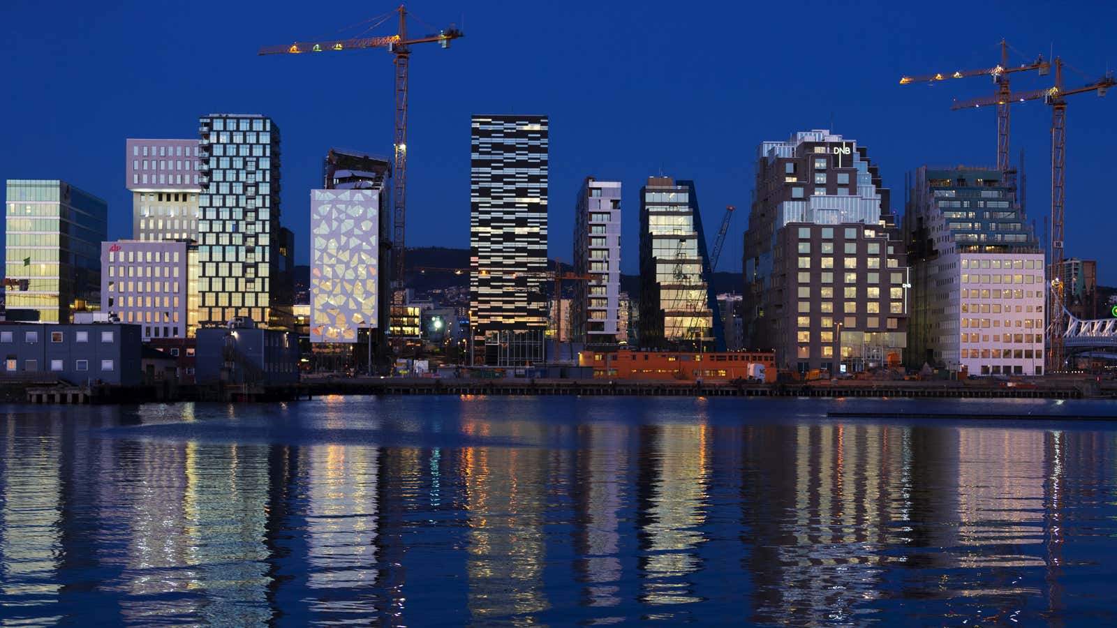 The sunset is reflected off the buildings of The Barcode Project in Oslo.