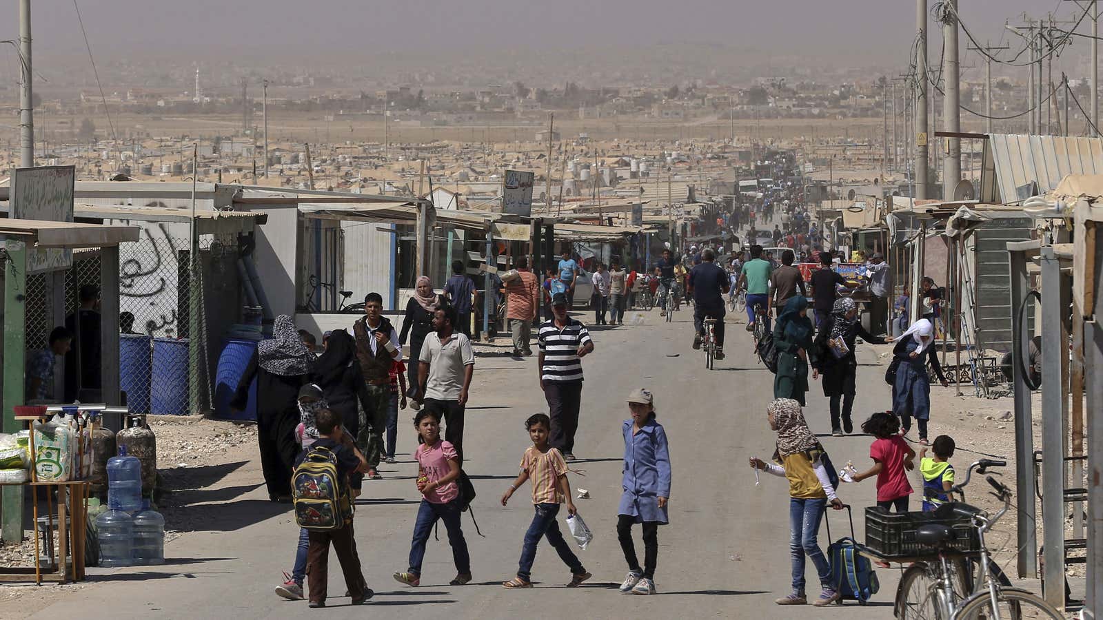Syrian refugee children stroll on the main street of the UN-run Zaatari refugee camp near Mafraq, northern Jordan.