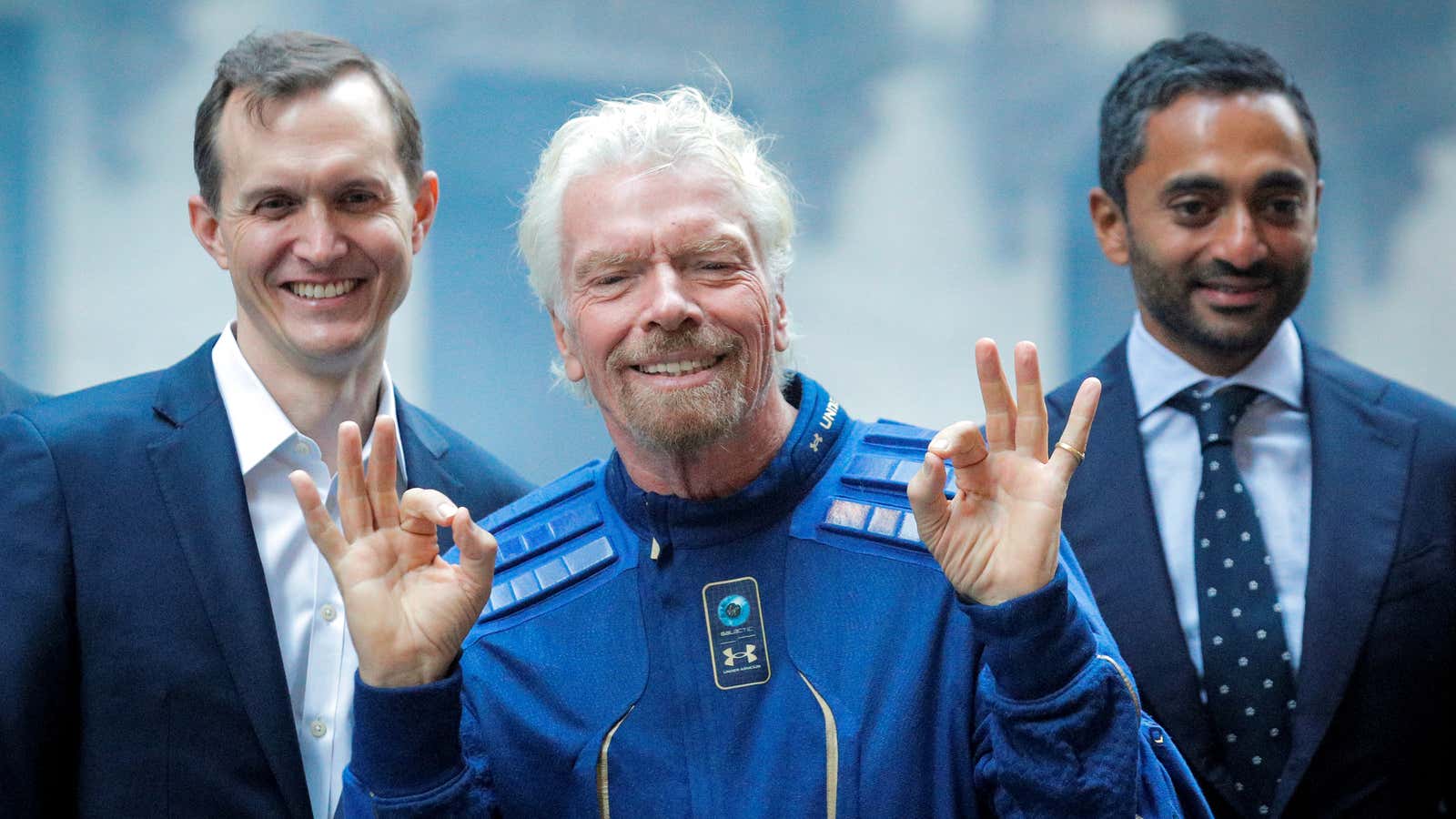 Richard Branson, center, celebrates Virgin Galactic’s first day as a public company.