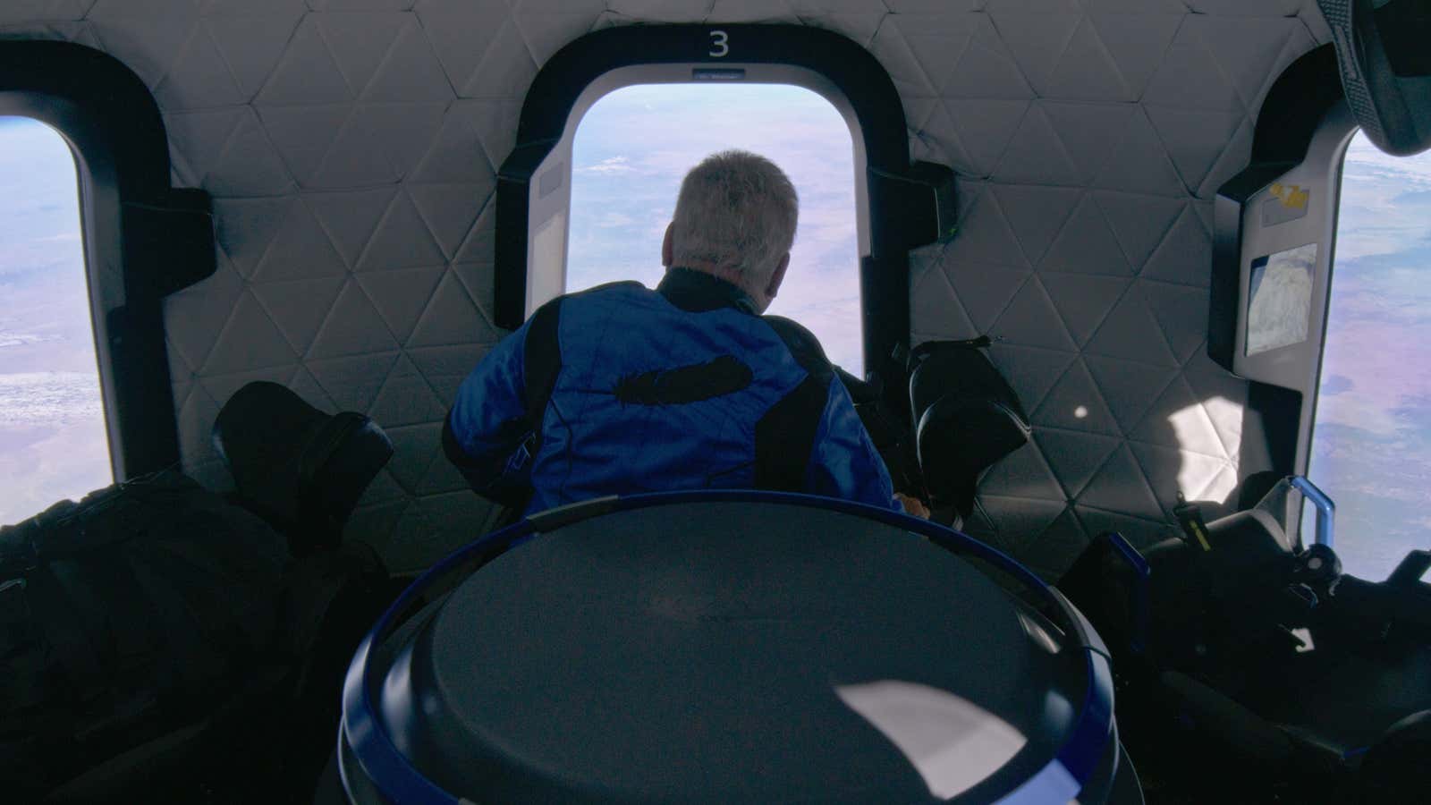 William Shatner looks out the window of Blue Origin’s New Shepard space capsule.