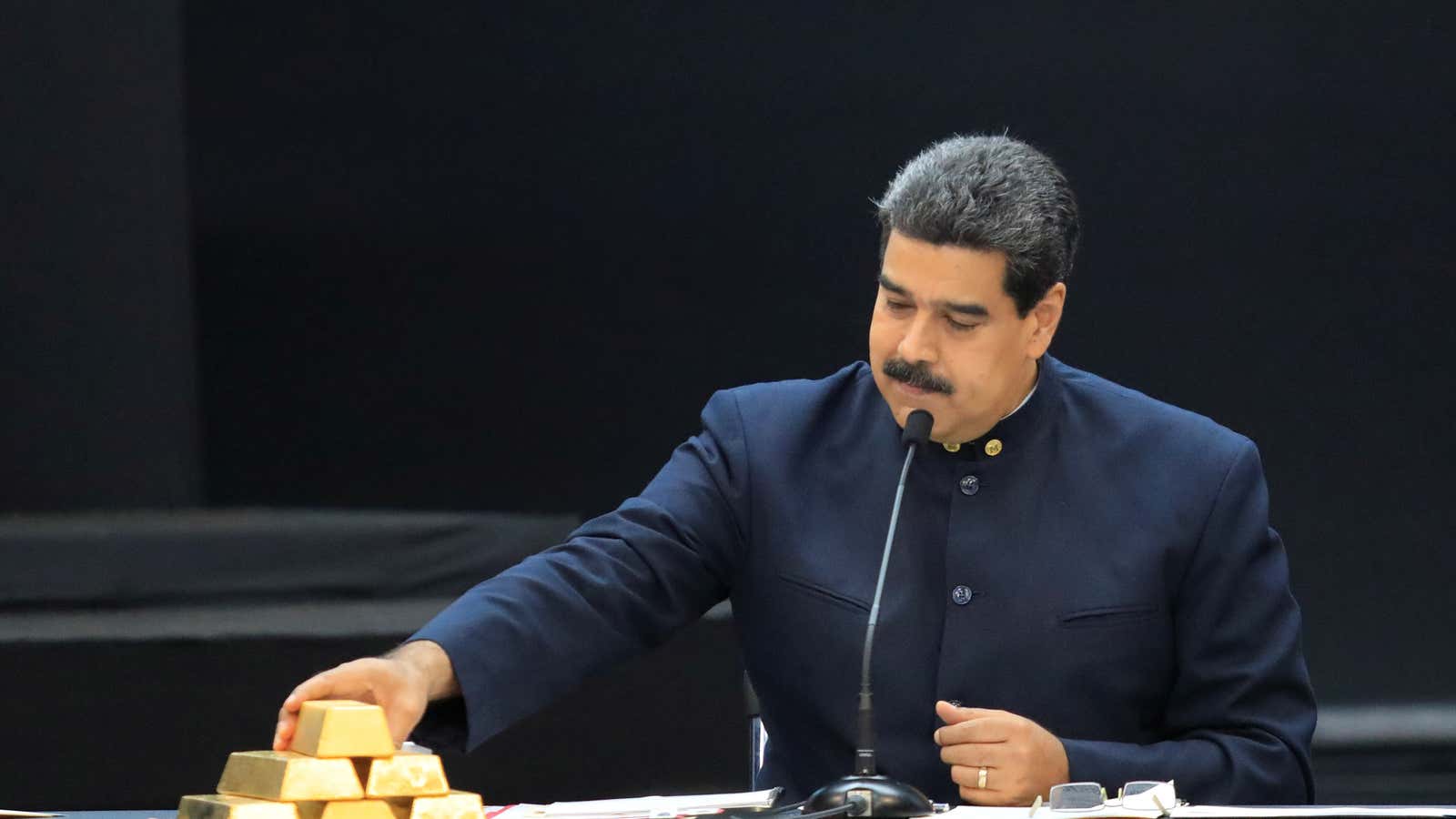Maduro handles a gold bar.