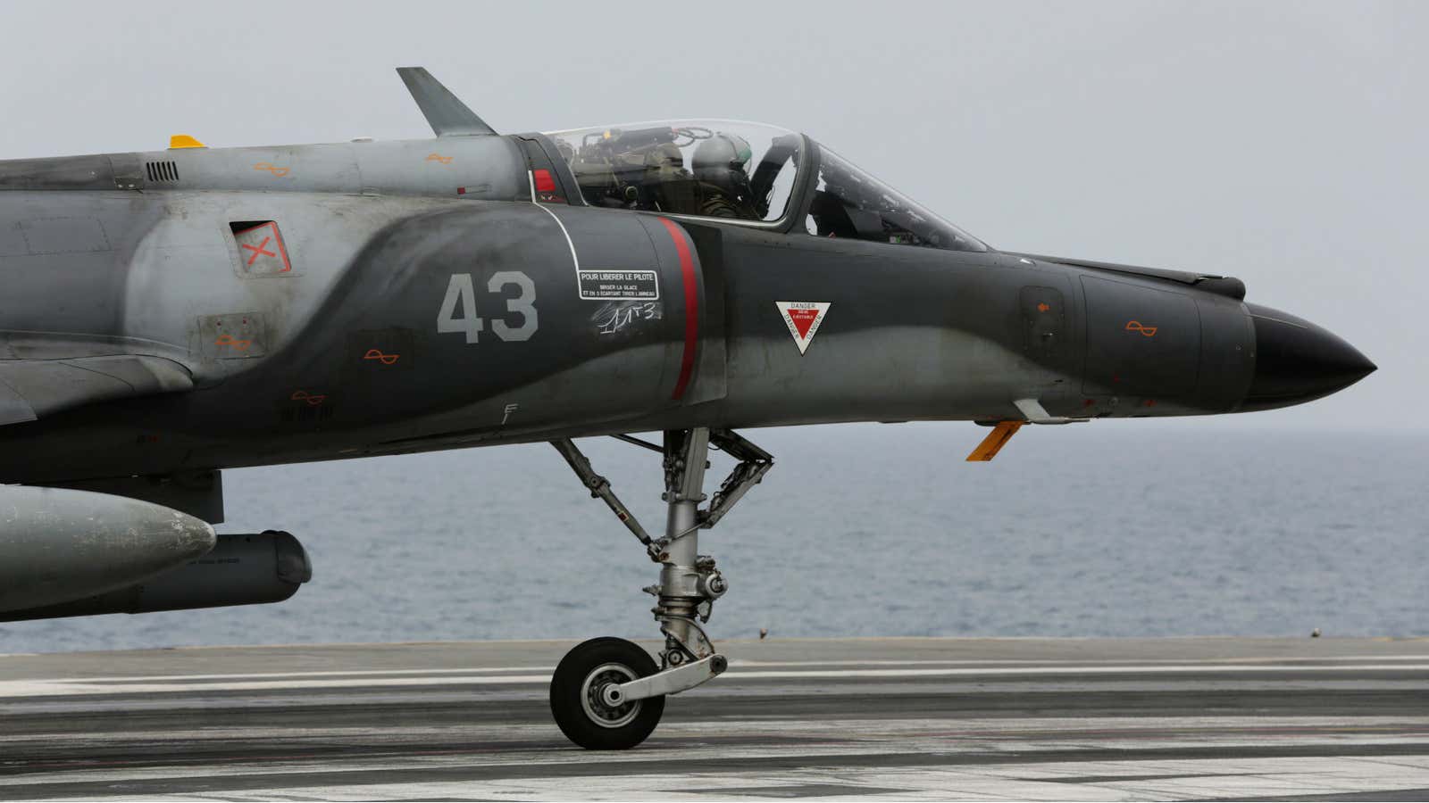 A French military plane lands on the French navy aircraft carrier Charles de Gaulle in the Persian Gulf in March 2015.