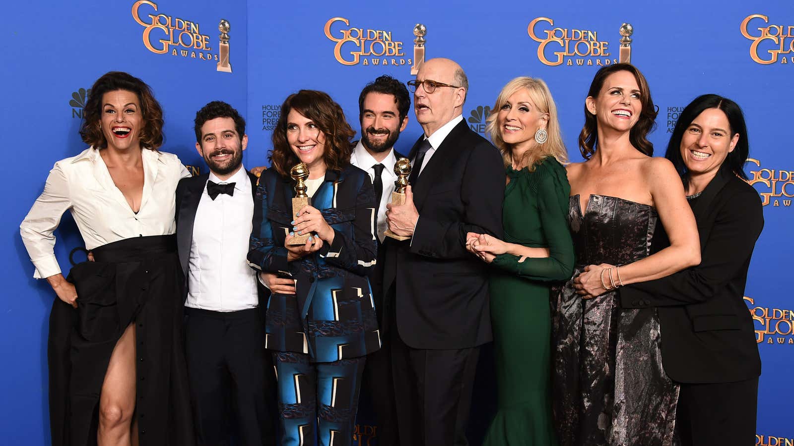 Program creator Jill Soloway and actor Jeffrey Tambor along with the cast of “Transparent” pose backstage with the Golden Globe award for Best Television Series – Comedy or Musical.