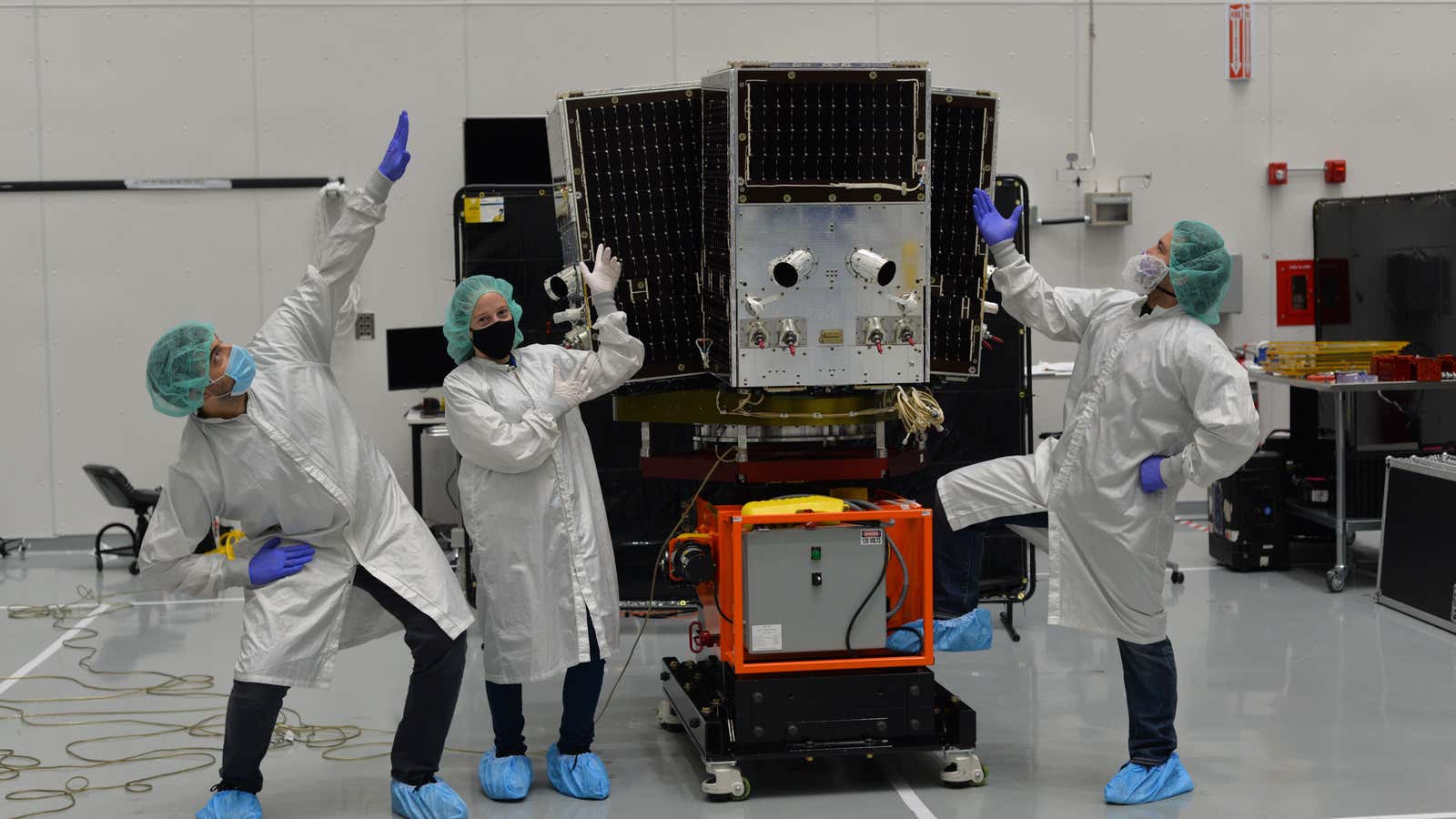 Planet staff Michael Soulage, Natasha Nogueira, Raul Antonio Perez prepare a SkySat for launch.
