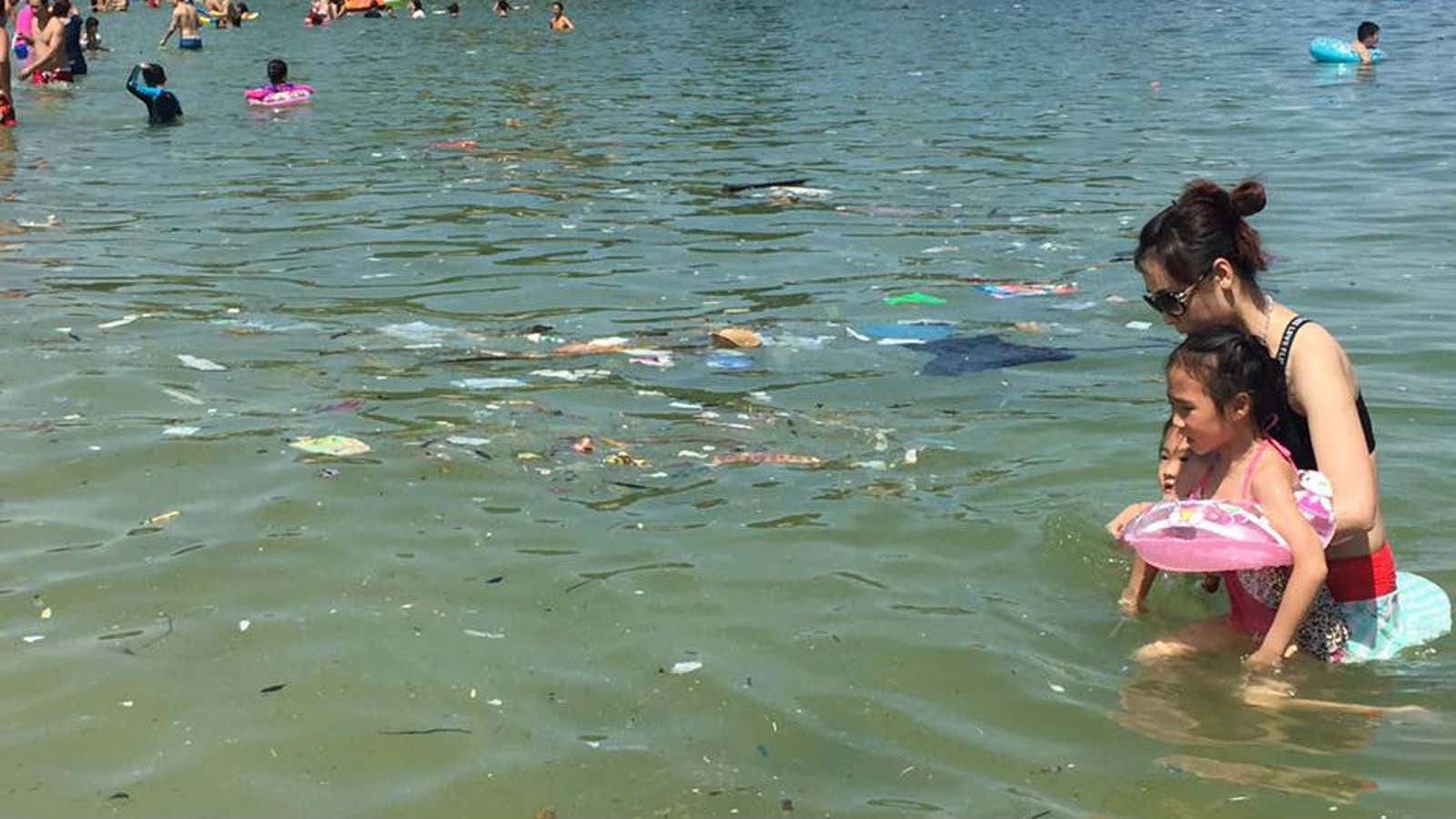 Trash floats in the waters of one of Hong Kong’s beaches.