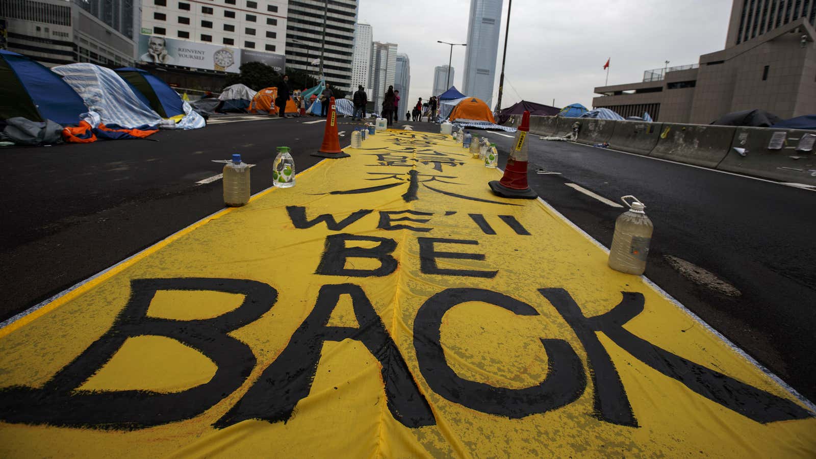 A huge banner set up by pro-democracy protesters lies on an overpass at the financial Central district in Hong Kong.