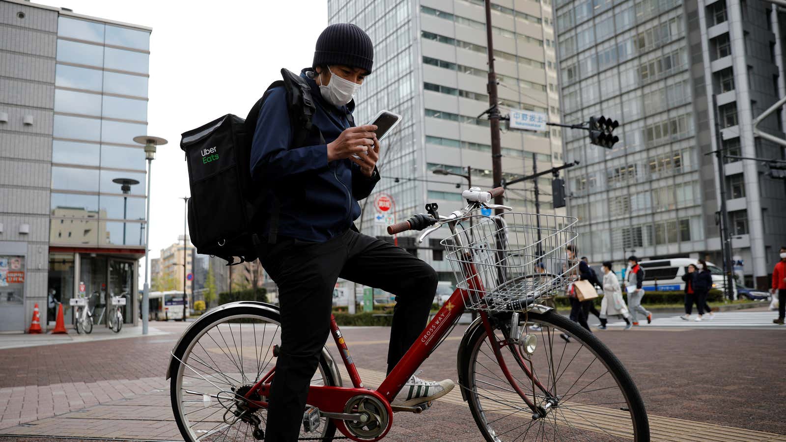 Taiga Fukutani, a comedian whose entertainment bookings dried up following the coronavirus disease (COVID-19) outbreak, works as an Uber Eats delivery man in Tokyo, Japan April 16, 2020. REUTERS/Kim Kyung-Hoon – RC2O5G9DOT9Q
