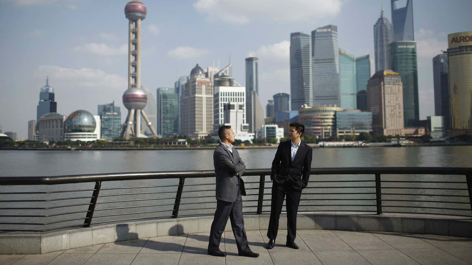 Businessmen walk on the Bund near Shanghai’s financial district.