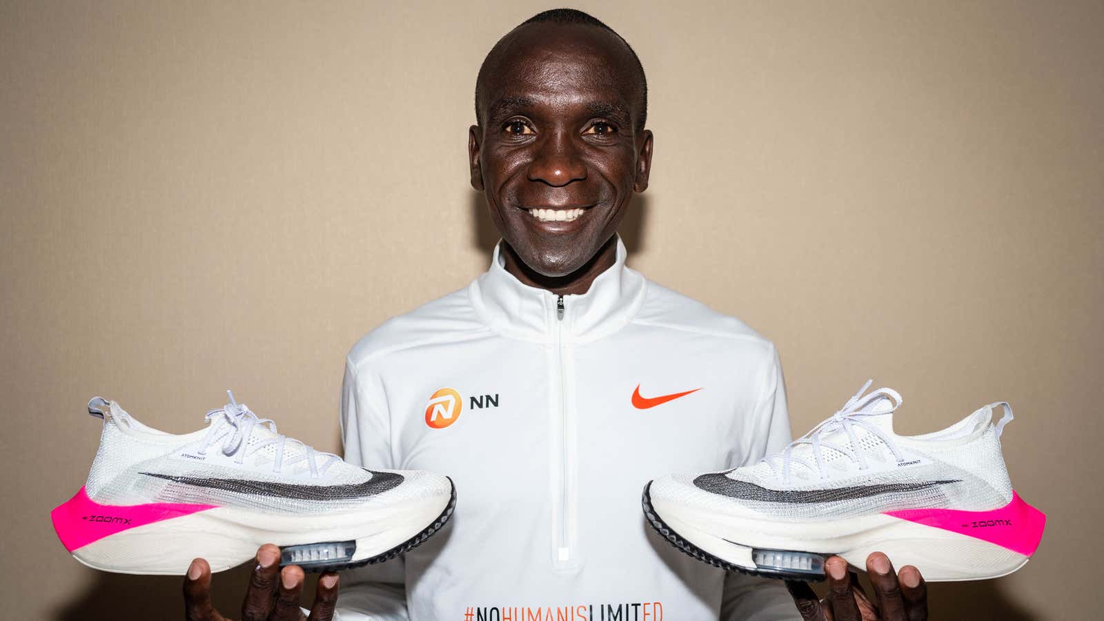 Eliud Kipchoge, holding up Nike’s controversial Vaporfly Next% running shoes.