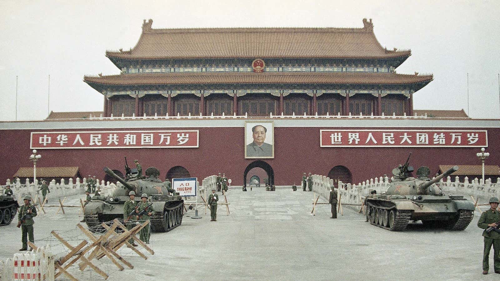 Peoples Liberation Army (PLA) troops standing guard with tanks in front of Tiananmen Gate. June, 1989.