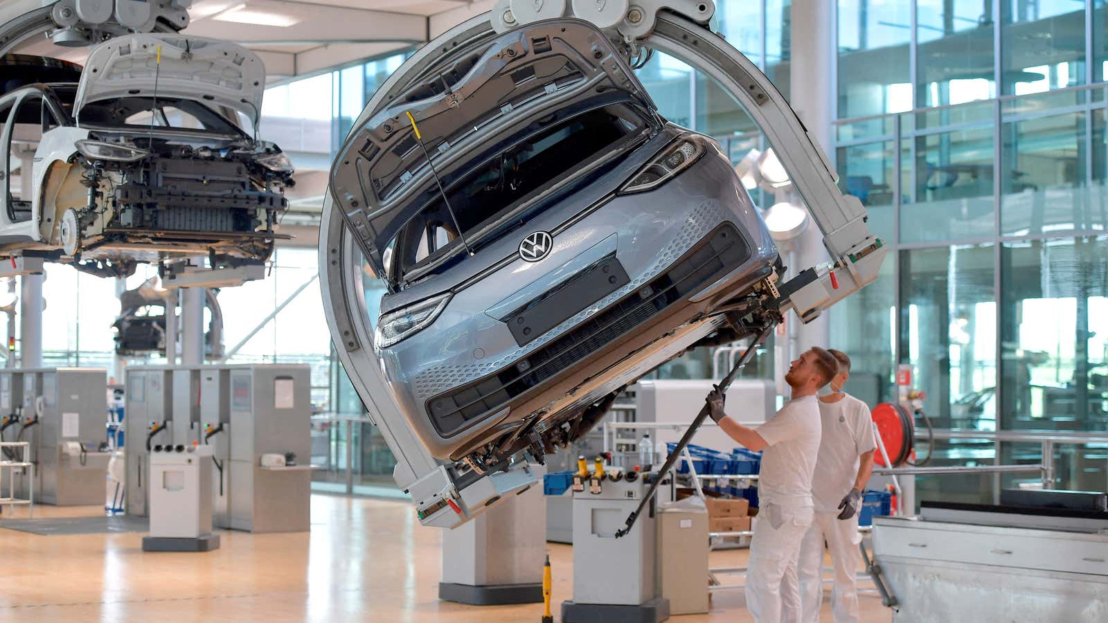Technicians work in the assembly line of German carmaker Volkswagen’s electric ID.3 car in Dresden, Germany.
