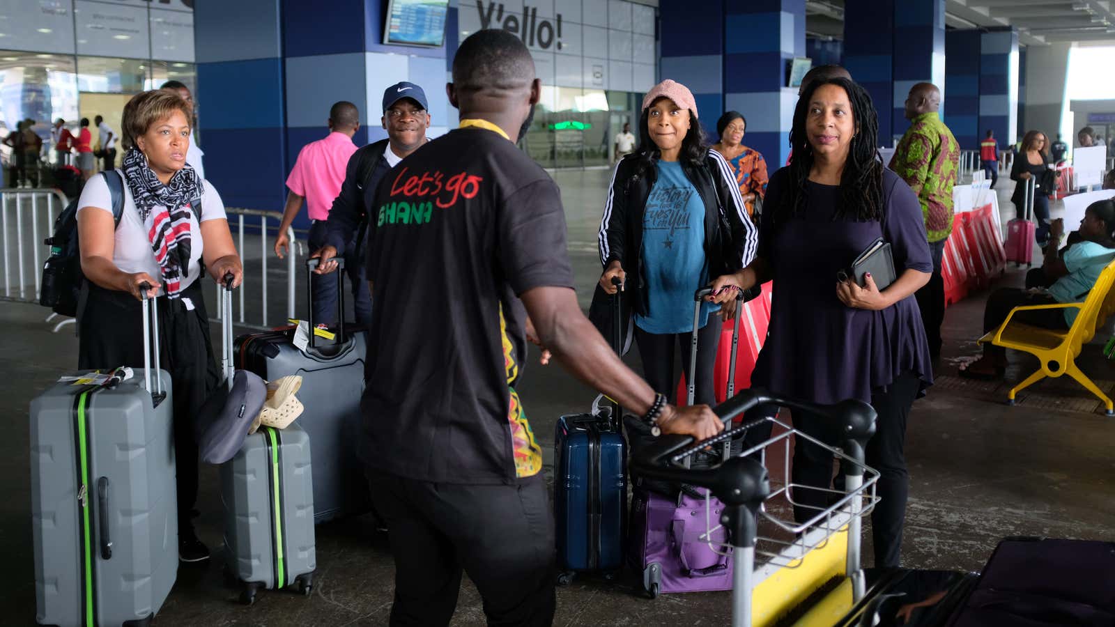 Tourists are welcomed by a tour guide at Ghana’s Kotoka International Airport, Aug. 6, 2019.