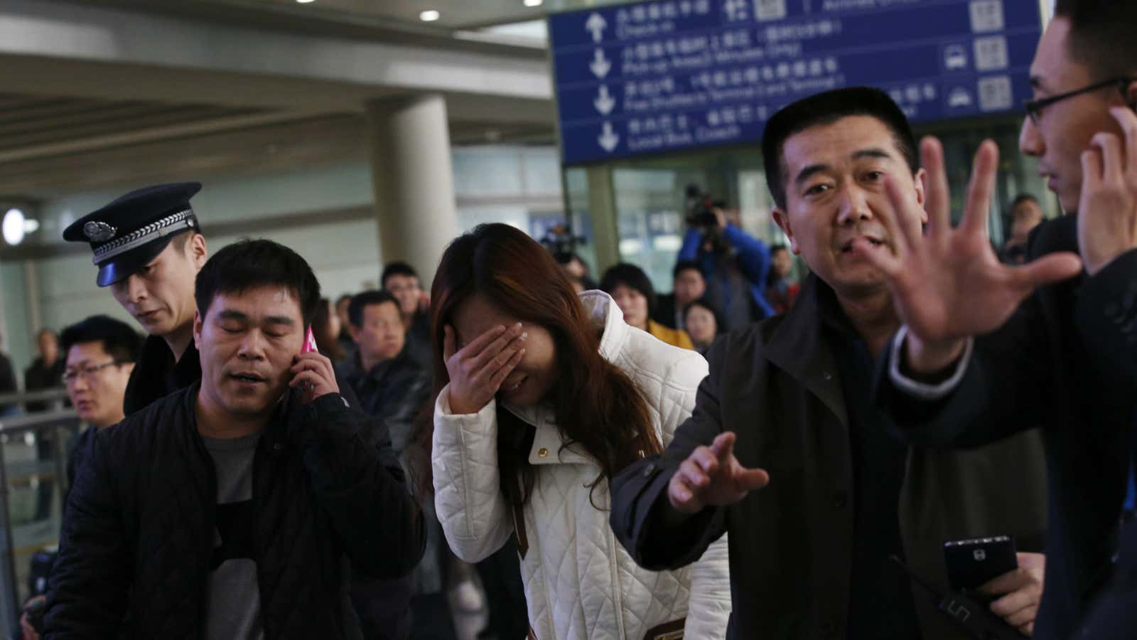 A woman in Beijing airport who is awaiting news of Malaysia Airlines flight MH370.